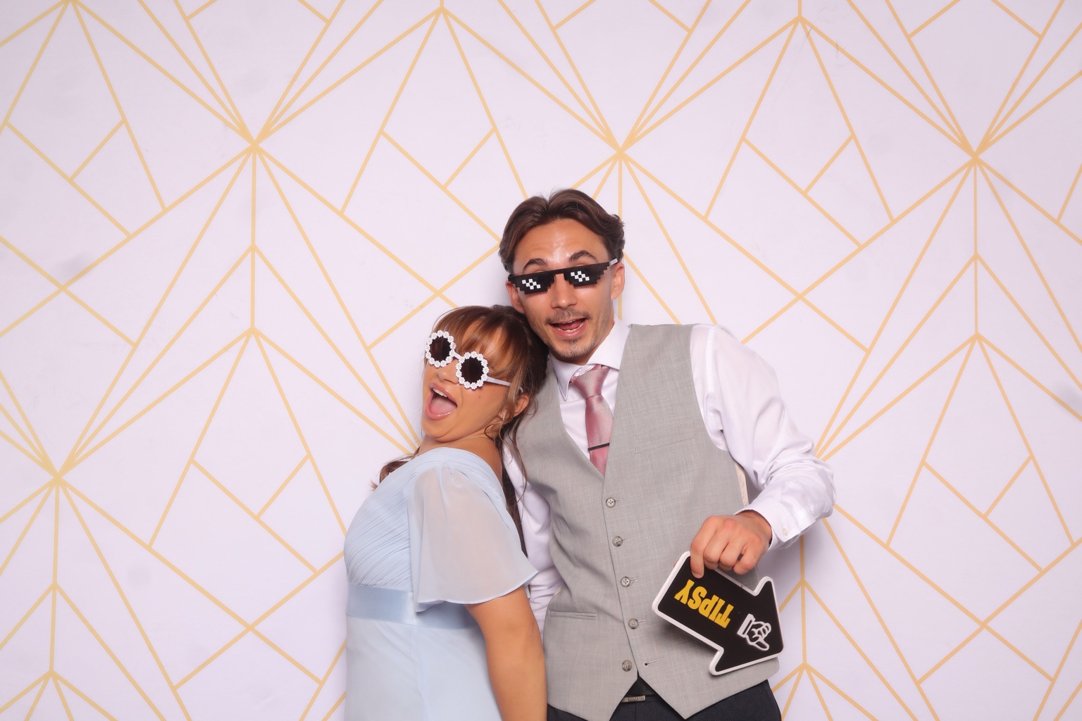 IkonikShots guests posing in front of a patterned backdrop